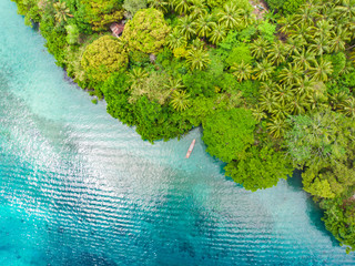 Aerial top down view tropical paradise pristine beach rainforest blue lagoon at Banda Island, Pulau Ay. Indonesia Moluccas archipelago, top travel destination, best diving snorkeling.