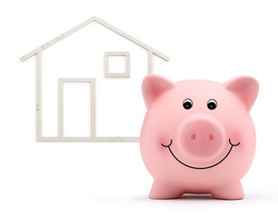 piggy bank with wood house shape isolated on white background, real estate and savings purchase concept