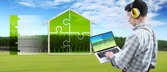 green house construction renovation concept handyman carpenter man with laptop computer and puzzle infographic list with the shape of a wooden house on nature background, 