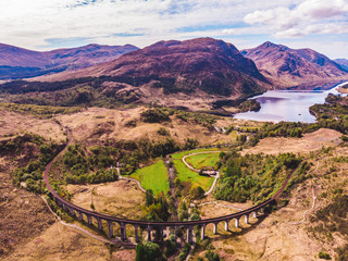 Glenfinnan viaduct and historical train in Scotland