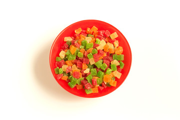 Red round plate full of colorful delicious candied fruits