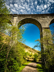 Glenfinnan viaduct and historical train in Scotland