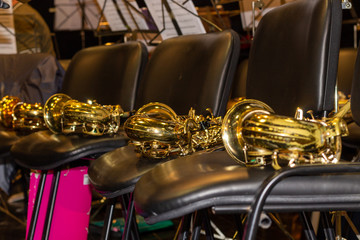 Saxophones lying on the chair.