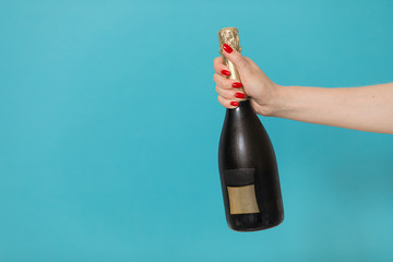 Party and holiday celebration concept. Champagne bottle on blue background.