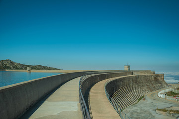 Pathway over dam wall forming a lake on highlands