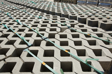 Fototapeta premium Concrete mesh stone for paving eco-friendly parking with grass. Warehouse paving.