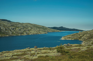 Fototapeta na wymiar Hilly landscape with lake on highlands