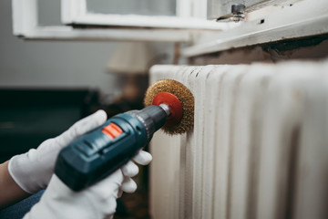 Beautiful and diligent middle age handywoman renovating her old home or apartment. She is holding...