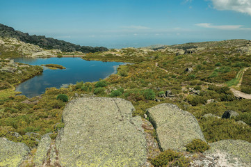 Fototapeta na wymiar Lake from dam in a rocky terrain on highlands