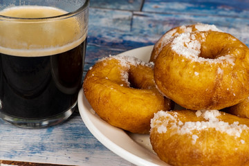 Fresh donuts with powdered sugar on the table