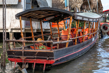 Fototapeta na wymiar Empty tourists boat with lifejackets cruising in the Mekong River Delta. Sa Dec. Vietnam, Indochina, SouthEast Asia.