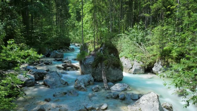 Creek with rocks in the forest in Bavaria, magic forest Hintersee, Germany, time lapse