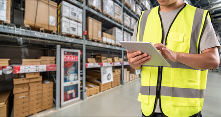 worker hand holding pad for check order pick time in smart factory warehouse