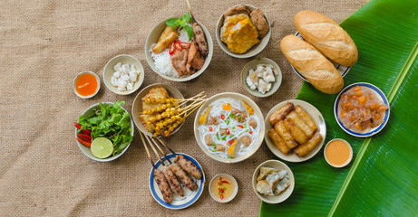 Vietnamese food background with spring roll, banh mi, banh canh, steamed fish ball, shrimp dumpling. Typical cuisine of south central of Vietnam like Binh Thuan, Ninh Thuan, Nha Trang province