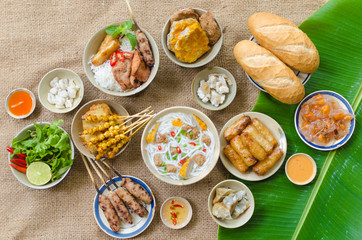 Vietnamese food background with spring roll, banh mi, banh canh, steamed fish ball, shrimp dumpling. Typical cuisine of south central of Vietnam like Binh Thuan, Ninh Thuan, Nha Trang province