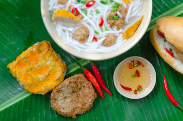 Banh Canh - Rice noodles soup with fried fish ball and Banh Mi Cha Ca - Vietnamese bread with fried fish and chili fish sauce inside. This is a typical combo for breakfast in south central of Vietnam