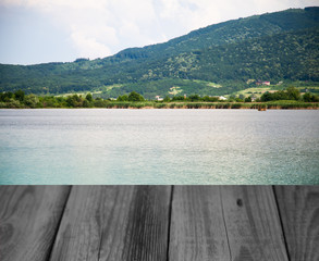 wooden table on the background of the lake with a mountain