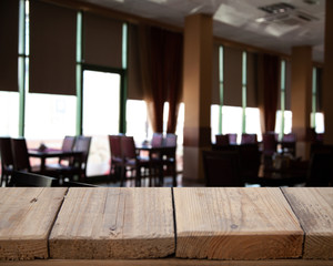vintage wooden table on blurred cafe background dining room restaurant