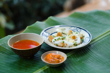 Banh Beo in Phan Thiet style. Banh Beo commonly calls Bloating Fern-shaped cake in English. It is kind of rice cake in small size use with shrimp and pork meat mixed tomato sauce