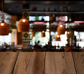 Fototapeta na wymiar vintage wooden table on blurred cafe background dining room restaurant