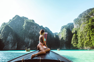 Beautiful woman making an excursion to phi phi island and maya beach in Thailand