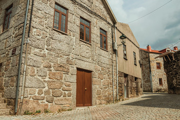 Fototapeta na wymiar Old house with stone wall in a deserted alley