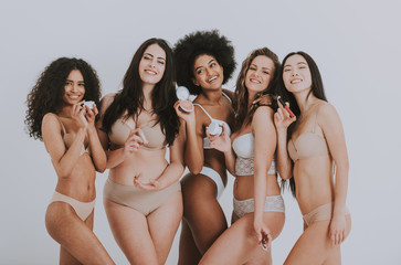 Group of women with different body and ethnicity posing together to show the woman power and strength. Curvy and skinny kind of female body concept