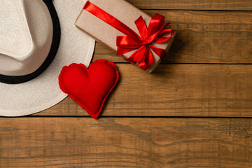 Set of elegant male accessories, men's fashion. Present, panama hat and fabric heart on rustic wooden background. The concept of father's day card, copy space for text.
