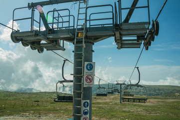 Chairlift towers and cables over hilly landscape