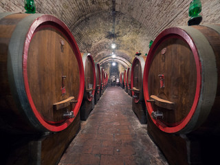 Oak barrels in an old underground wine cellar.