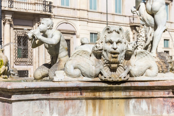 Detail sculpture of a triton, greek God. The Moor Fountain (Italian: Fontana del Moro) in Navona Square, Rome, Italy.