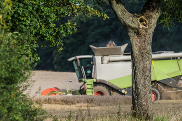 AGRICULTURAL MACHINE - A modern combine harvester work in the field during harvest time