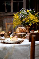 beautiful outdoor still life in country garden with bundt cake on wooden stand on rustic table