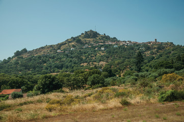 Fototapeta na wymiar Hilly landscape with the small Monsanto village on top