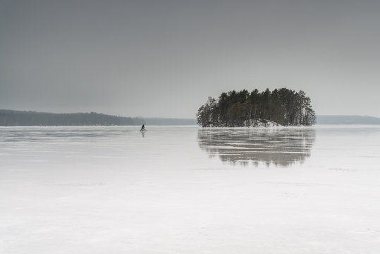 Man sledging on frozen lake