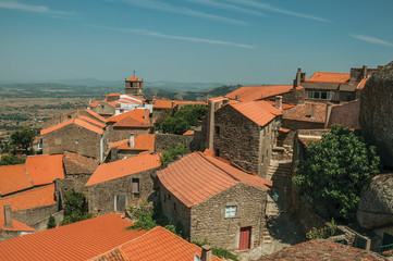 Fototapeta na wymiar Rooftops of old houses with church steeple in Monsanto