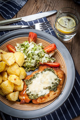 Fried chicken fillet with spinach and cheese.