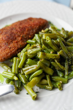 Close Up Of Deep Fried Chicken Schnitzel With Crunchy Crust And Steamed Green Beans For A Nutritious Lunch