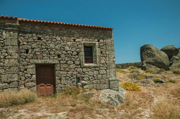 Stone house on rocky hilltop at the Castle of Monsanto