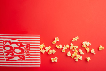 Paper packaging with popcorn on a colored background