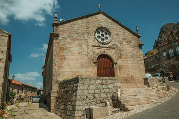 Medieval church facade with stone wall at Monsanto