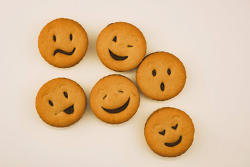 tasty cookies with different emotions on an isolated background