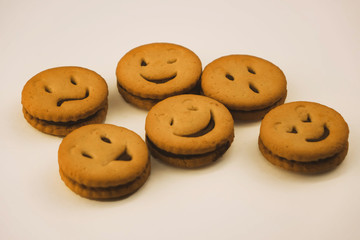 tasty cookies with different emotions on an isolated background