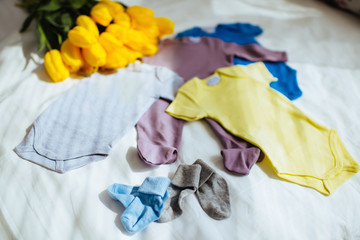 Baby clothes on fabric background copy space