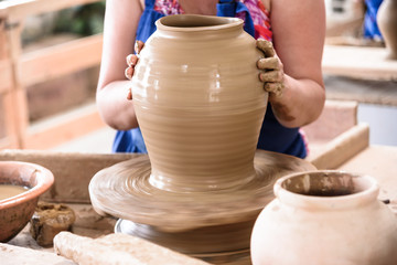 how to do a ceramic vase, capture of a worker modeling clay to creat a ceramic vase