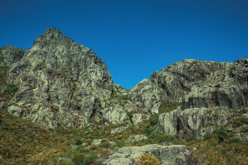 Landscape with rocky cliffs covered by green bushes