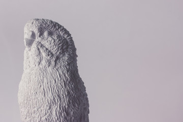 White plaster sculpture wavy parrot on a white background