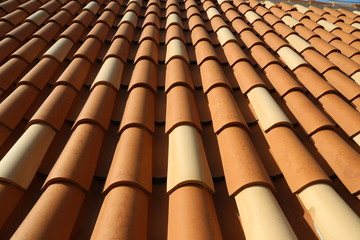 Red tile roof. Roof tiles on the roof © leomalsam