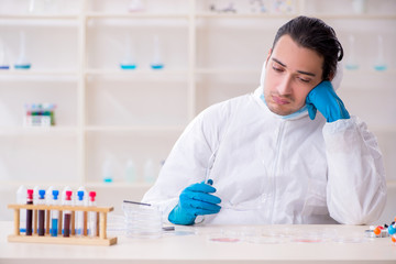 Young male chemist working in the lab 