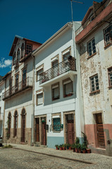 Old houses with worn plaster and wooden doors